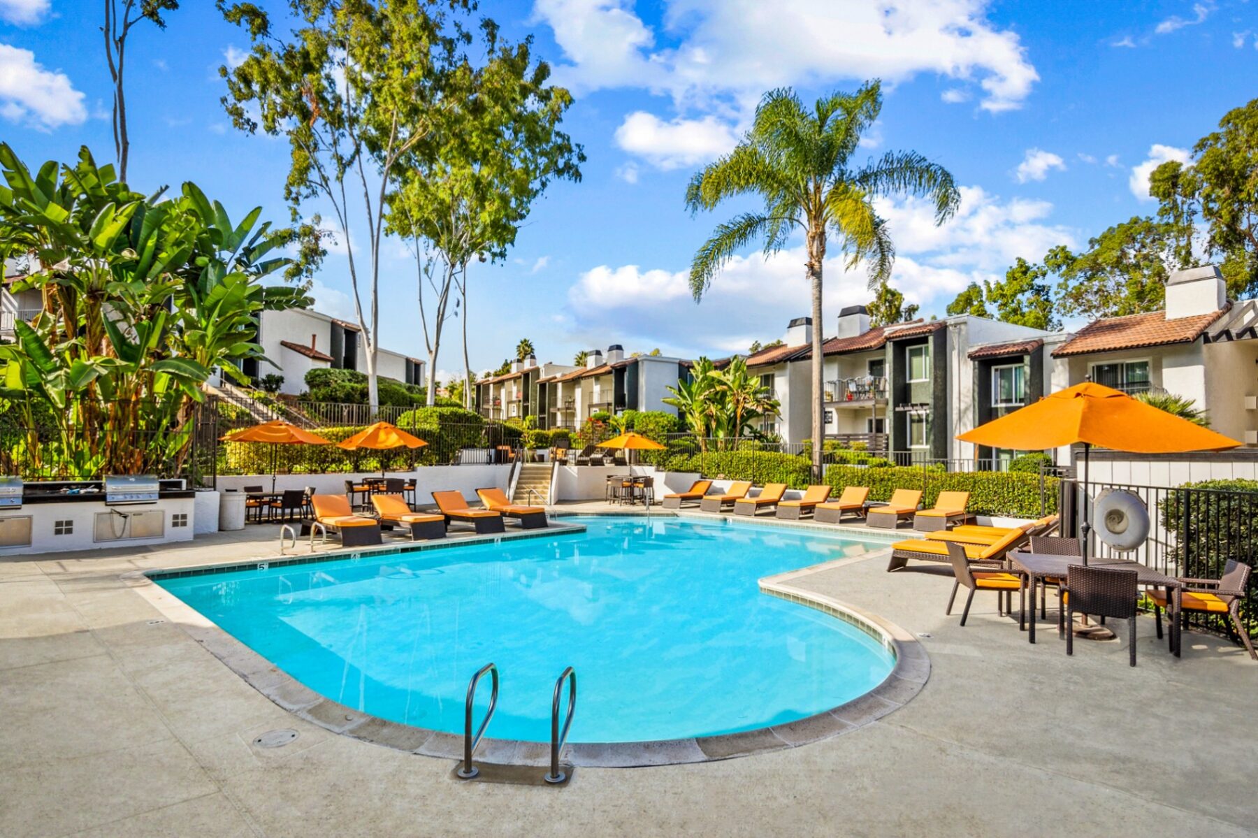 Pool with loungers with background of Madera Ridge apartments in North San Diego County
